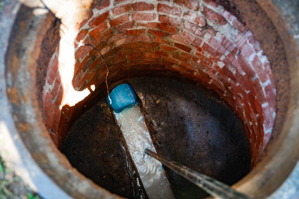 Workers installing CIPP lining in a sewer pipe, showcasing the trenchless technology process for pipe rehabilitation.