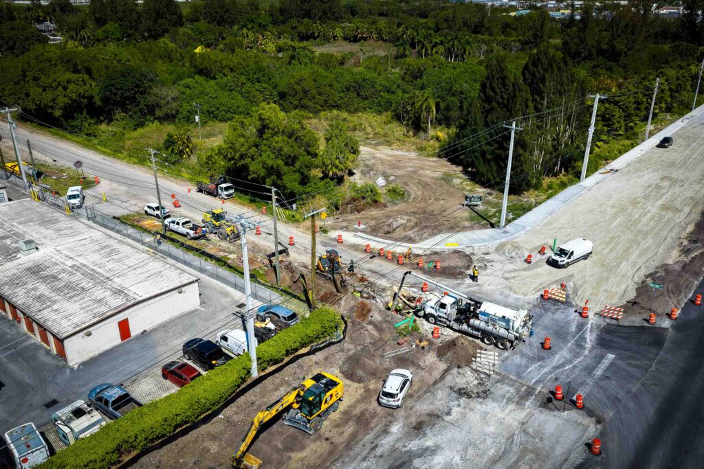 Hydro excavation process with a large vacuum truck removing soil, showcasing efficient and precise digging in urban area.