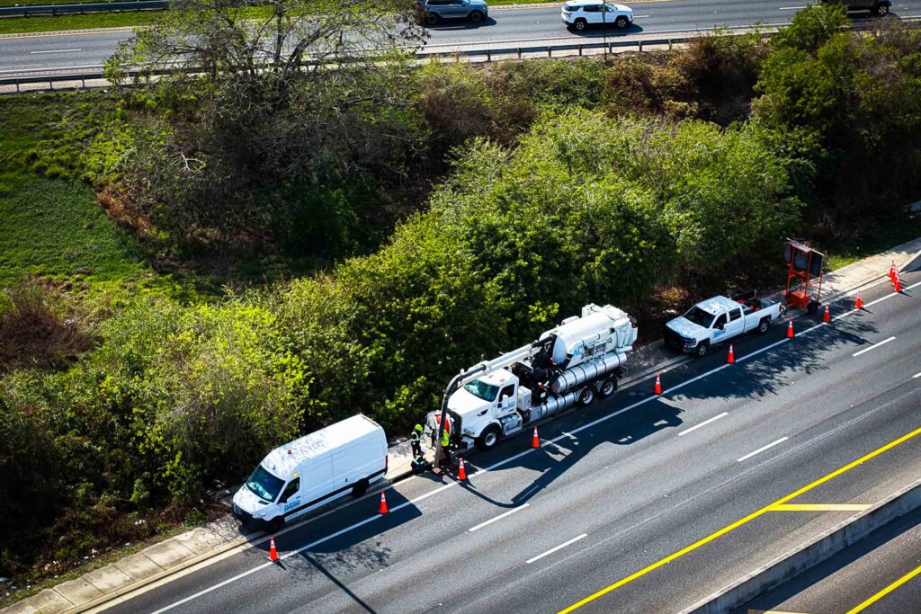 Jet vac truck performing CCTV pipe inspection, showcasing advanced cleaning technology in urban environment.