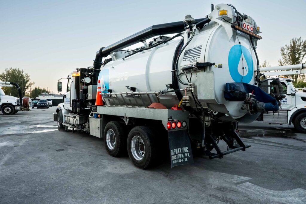 Vactor truck performing jet-vac cleaning on a city street, showcasing its powerful suction and cleaning capabilities.